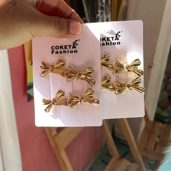 Set de 4 hebillas doradas forma de moño
