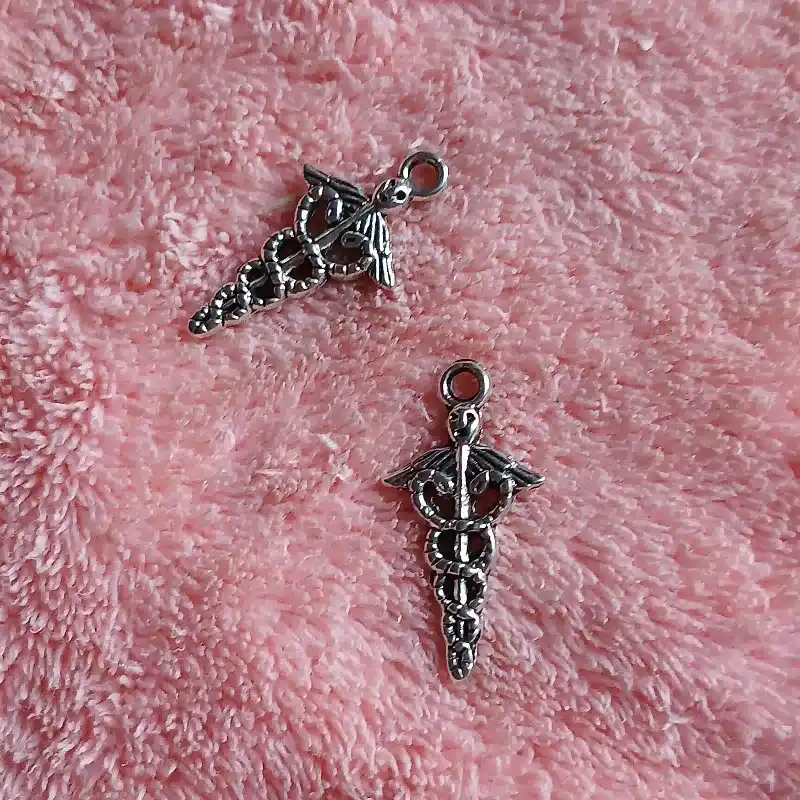 Dije símbolo Comercio o Economía