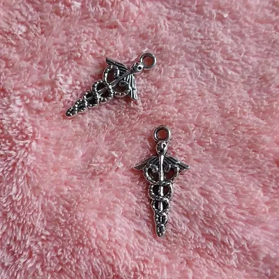 Dije símbolo Comercio o Economía