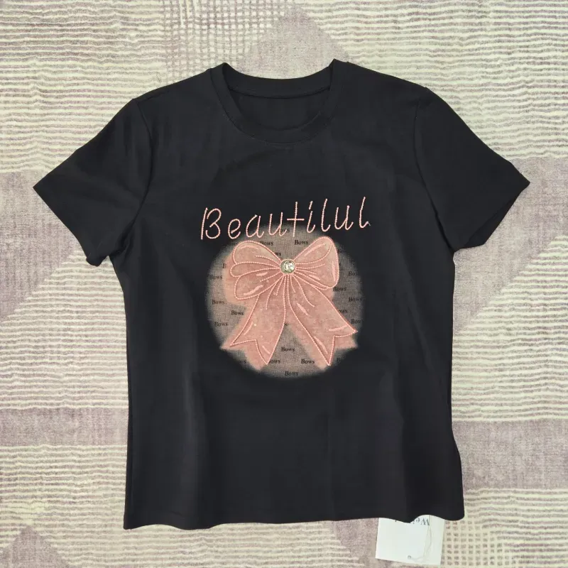 Pulover negro lazo rosado