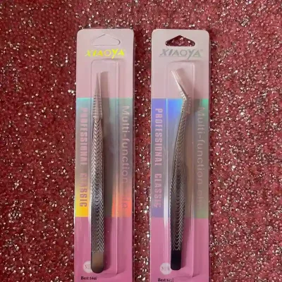 Par de pinzas para la aplicación de extensiónes de pestañas