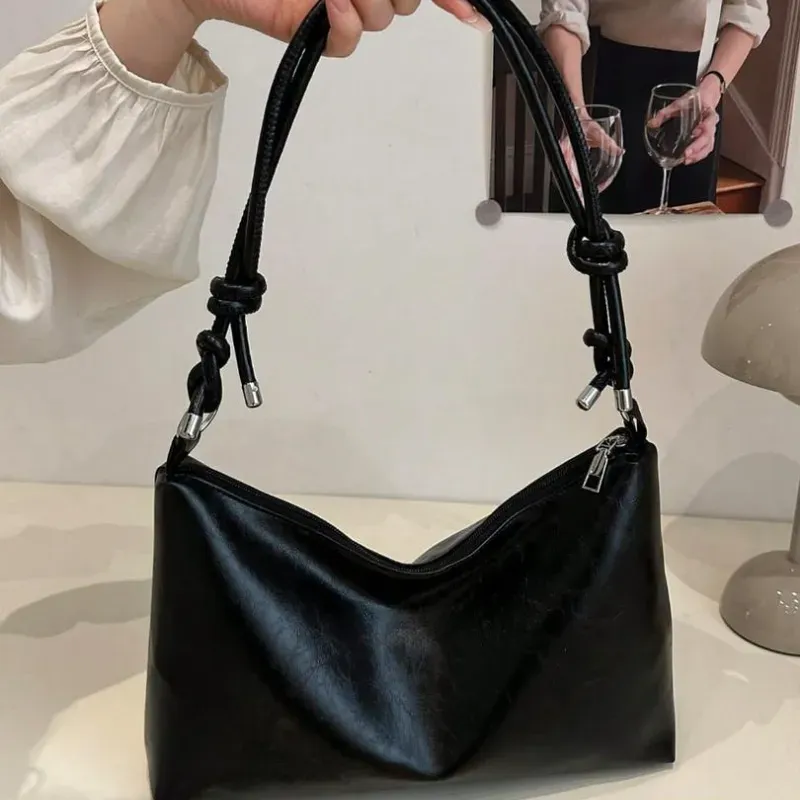 Bolso negro de diseño relajado y estructura semiblanda