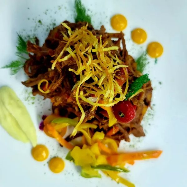 Ropa vieja de res/ Cuba's national dish-a stewed & shredded served with sweet fried plantain