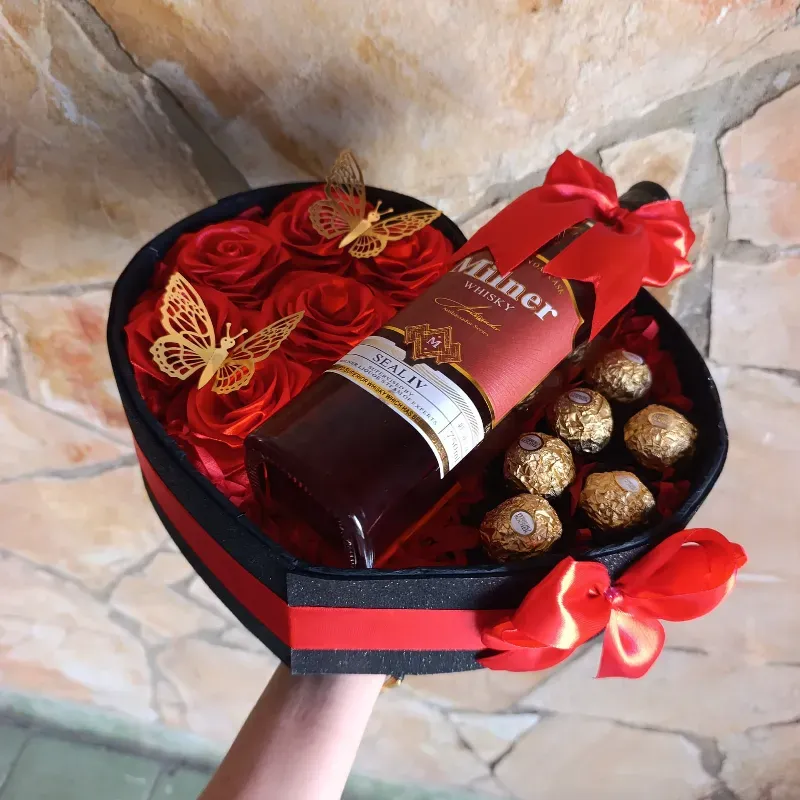 Corazón decorado de bombones y botella de ron