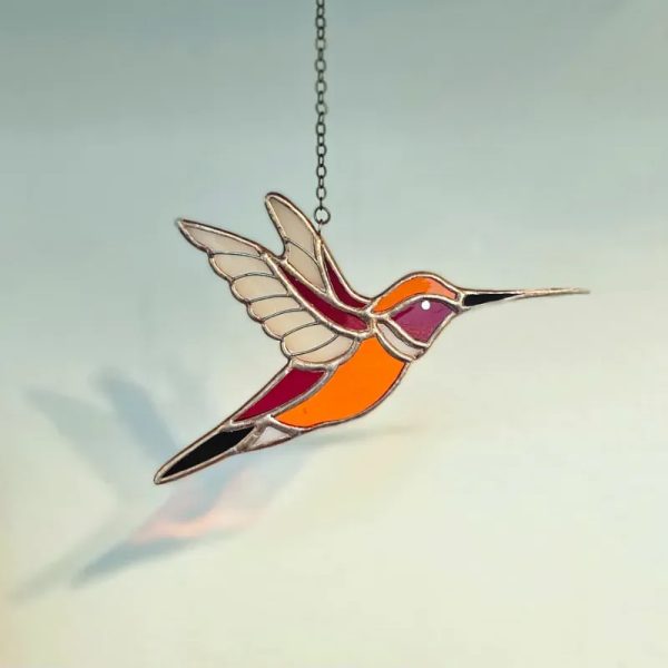 Colibrí naranja de alas abiertas