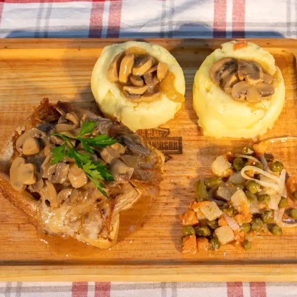 Fat Bob Roast pork on sliced bread with brown gravy with onions and mushrooms, served with mashed sweet potatoes, corn and roasted pumpkin.